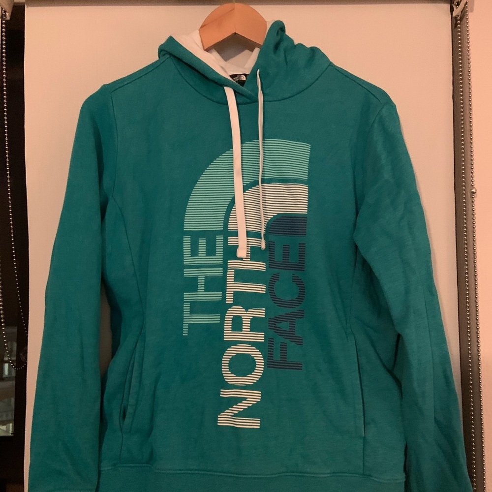 Turquoise North Face pullover hoodie.